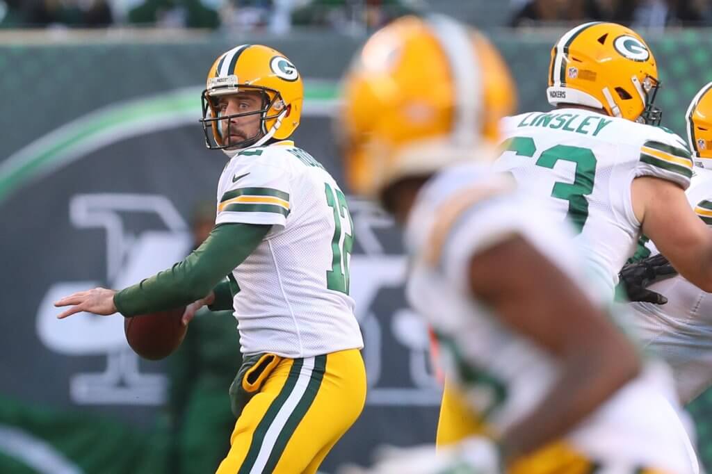 Aaron Rodgers winds up to deliver a downfield strike.