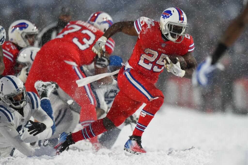 LeSean McCoy carries the ball in the snow.