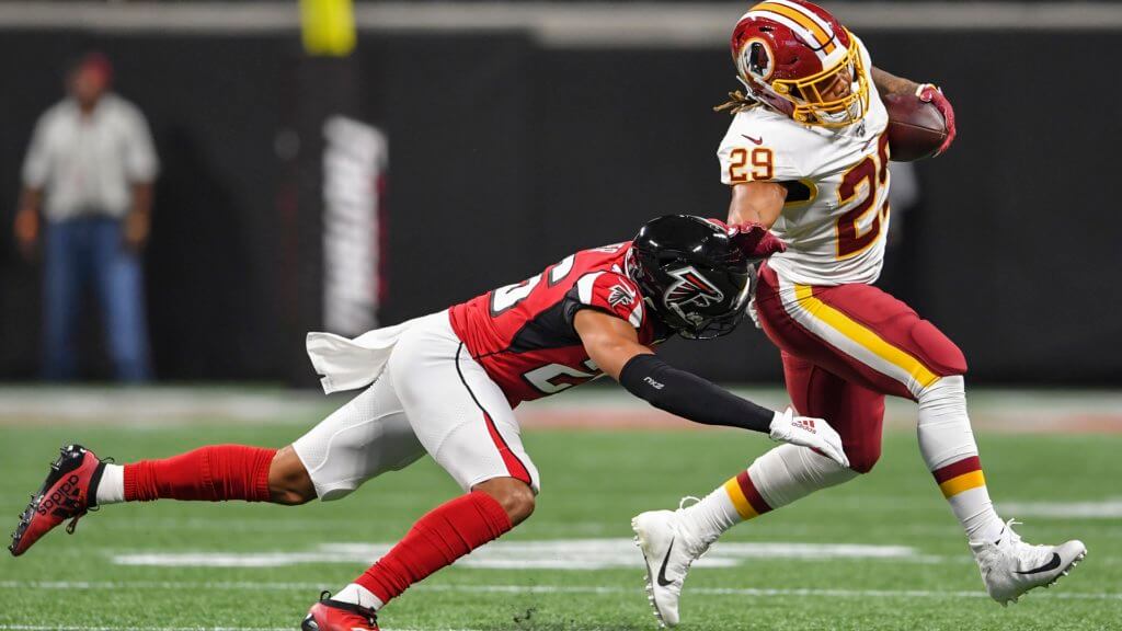 Washington RB Derrius Guice is hit by Atlanta FS Isaiah Oliver during the first quarter at Mercedes-Benz Stadium | Fantasy Football Dynasty Watch