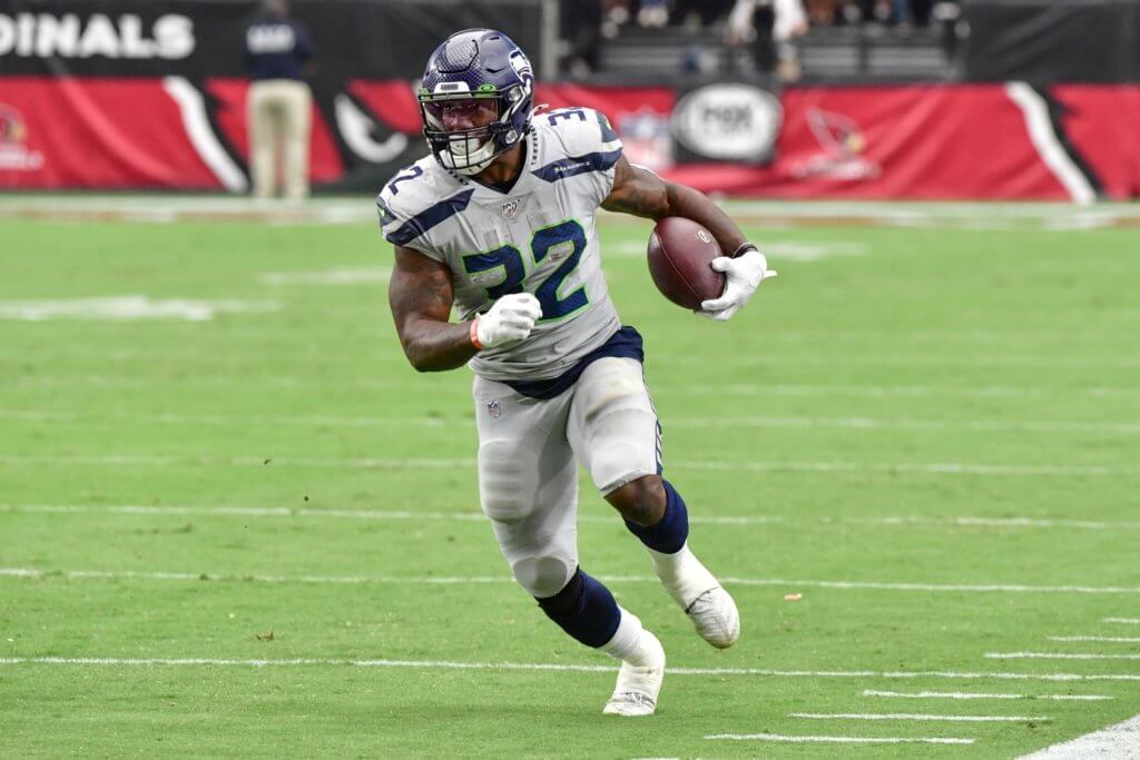 chris carson running the ball
