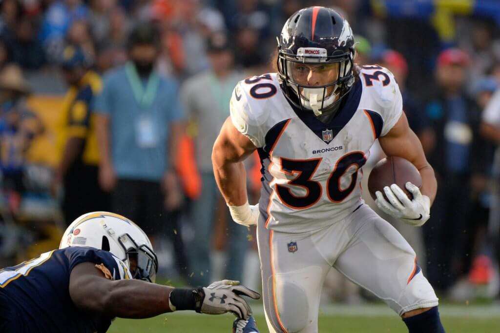 Phillip Lindsay runs the ball against the Chargers.