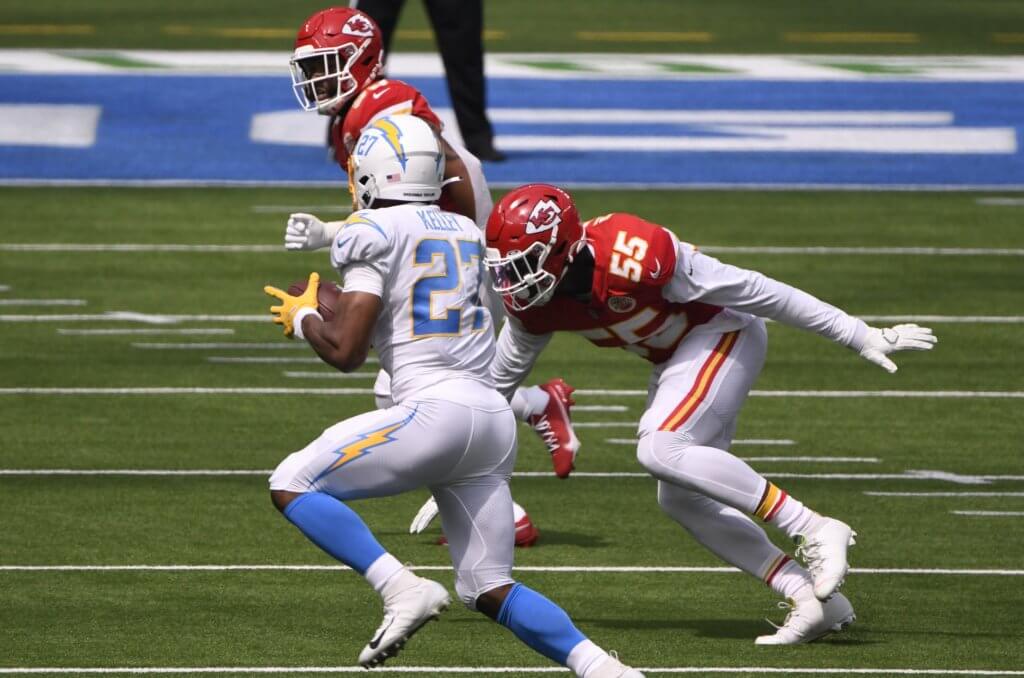 Joshua Kelley carries the ball against the Chiefs.