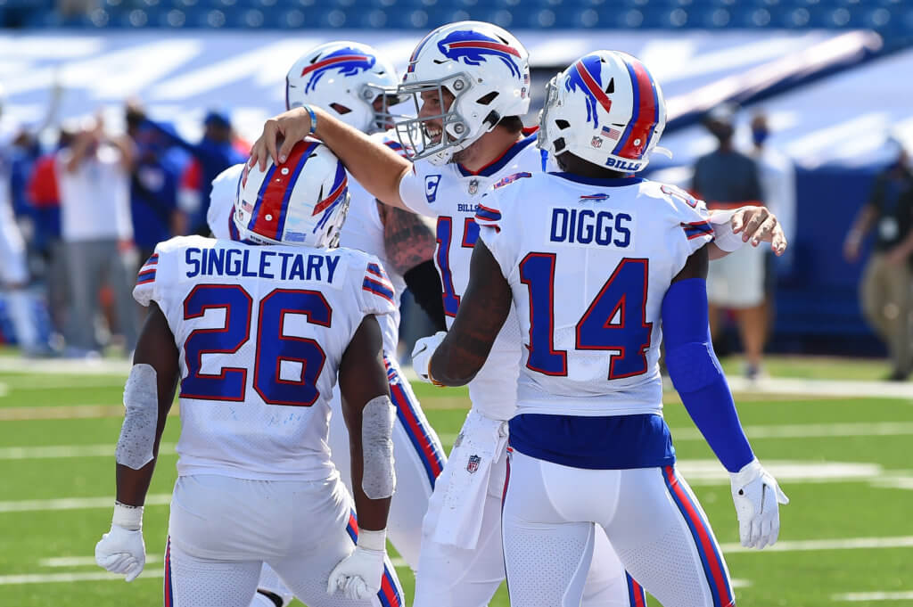 Bills' QB Josh Allen celebrates with teammates after rushing in a touchdown.
