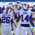 Bills' QB Josh Allen celebrates with teammates after rushing in a touchdown.