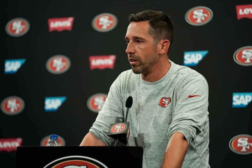 Kyle Shanahan conducts a press conference.