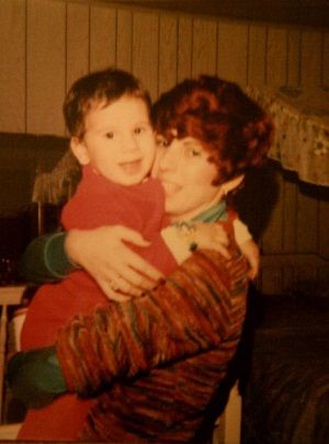 Image of a young Rob Povia being held in his mother's arms